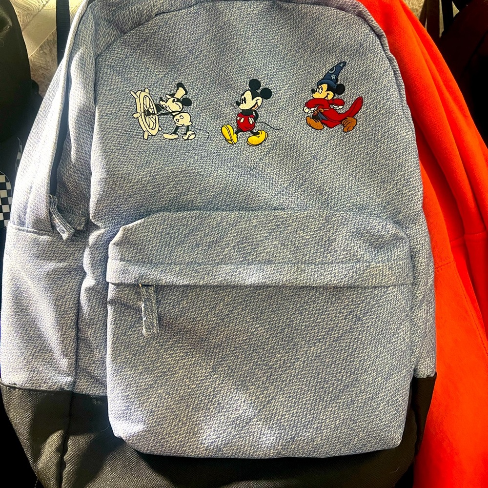 Original Disney backpack displaying Mickeys progression through the years